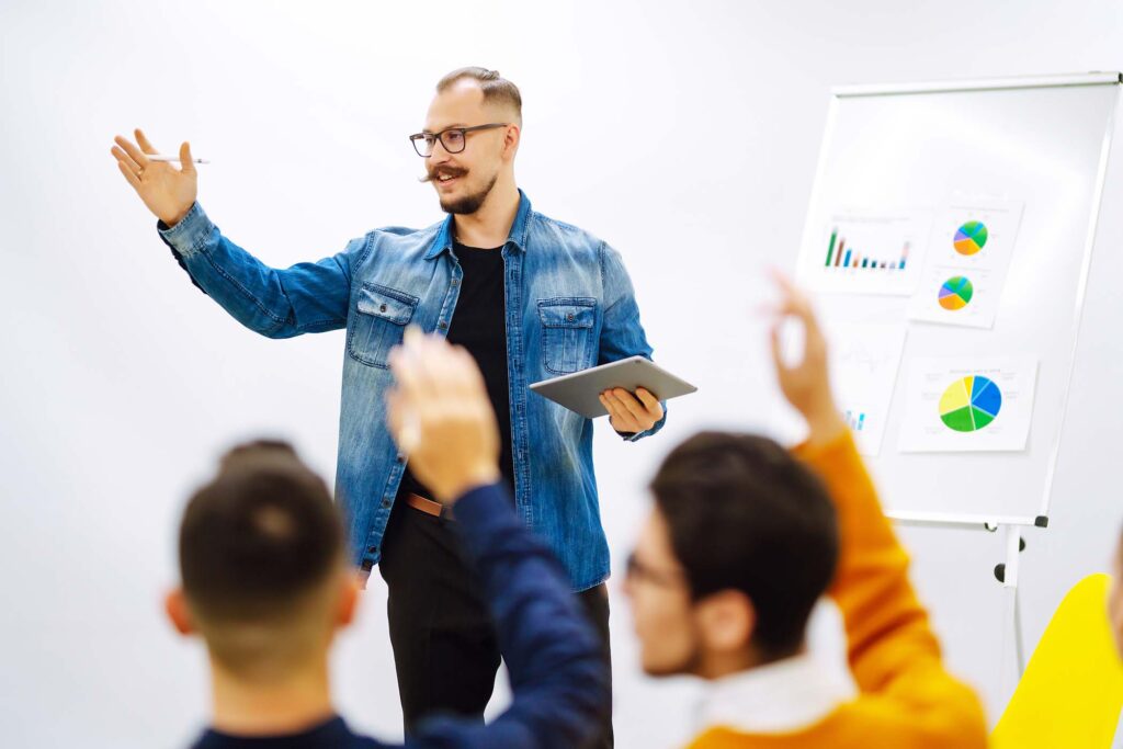 male-business-coach-speaker-giving-flipchart-prese-JND289M.jpg